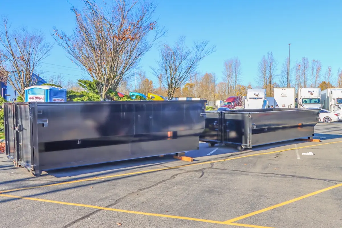 Professional dumpster rental service with roll-off container on residential driveway in Mount Joy